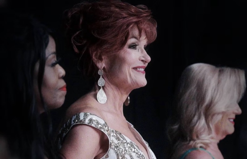 Pageant contestants on stage in a still from How to Be Queen