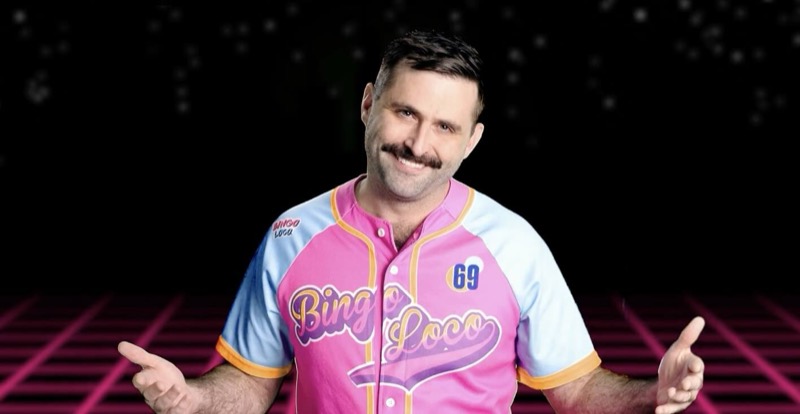 Scott Rowan smiling, arms out, in a pink Bingo Loco jersey